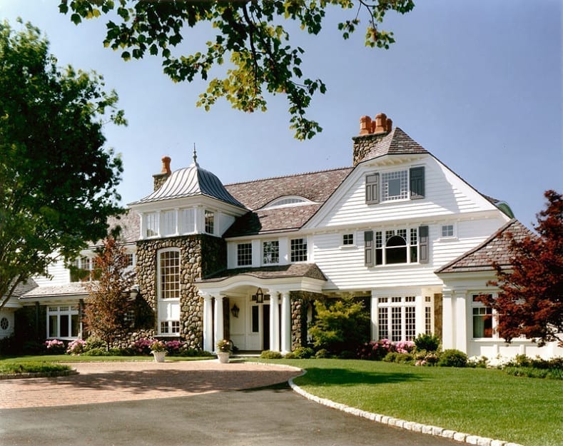 Front entry of New England style home with custom wood windows