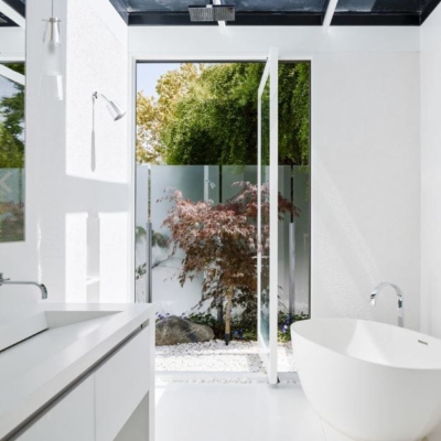 Wood and glass pivot opening the bathroom to outdoors