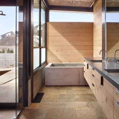 Modern bathroom with concrete style tub and steel windows