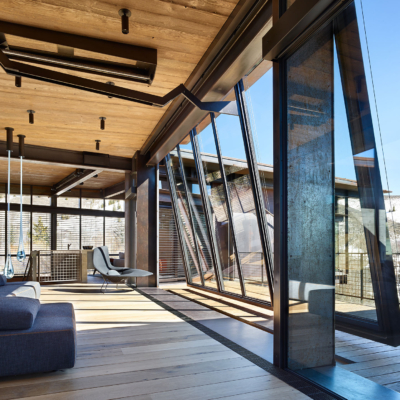 Massive steel and glass window wall tilts open