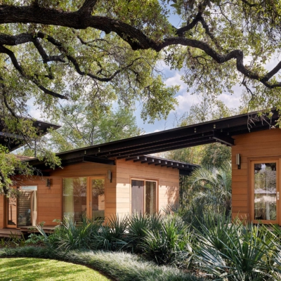 Modern lakefront house surrounded by trees