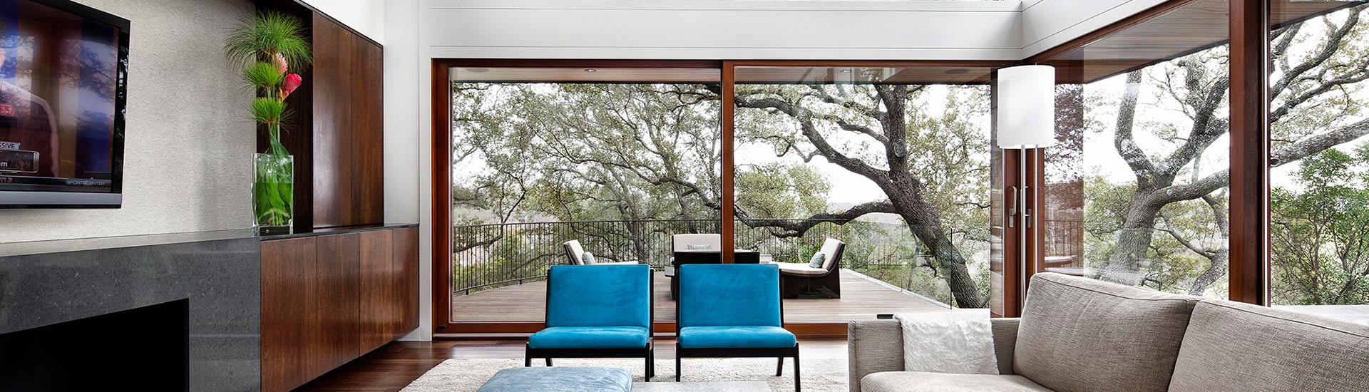 Wood lift and slide doors with view to trees outside