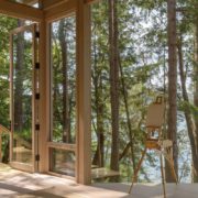 Looking out of a beautiful modern mountain home with floor to ceiling custom glass windows.