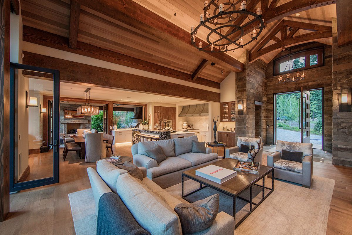 Architectural fenestration view of living room with modern wood pivot door with glass