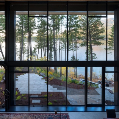 Guillotine window by Olson Kundig overlooking a lake